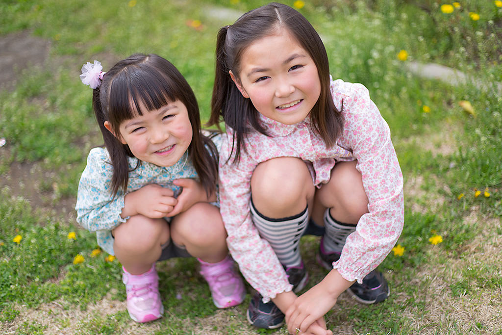 Two girls in field with creamy f/1.8 bokeh