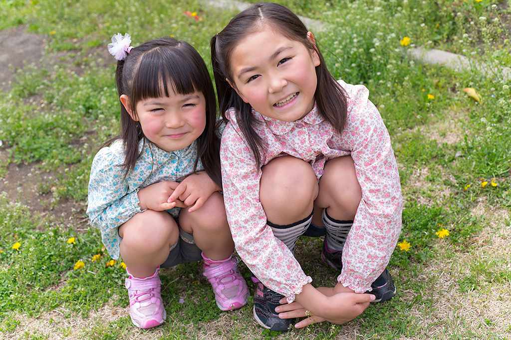 Two girls in field with f/5.6 bokeh