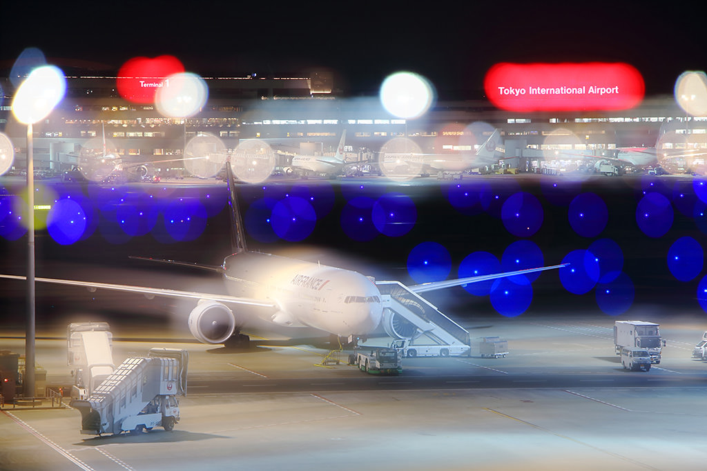 Plane at airport with bokeh lights