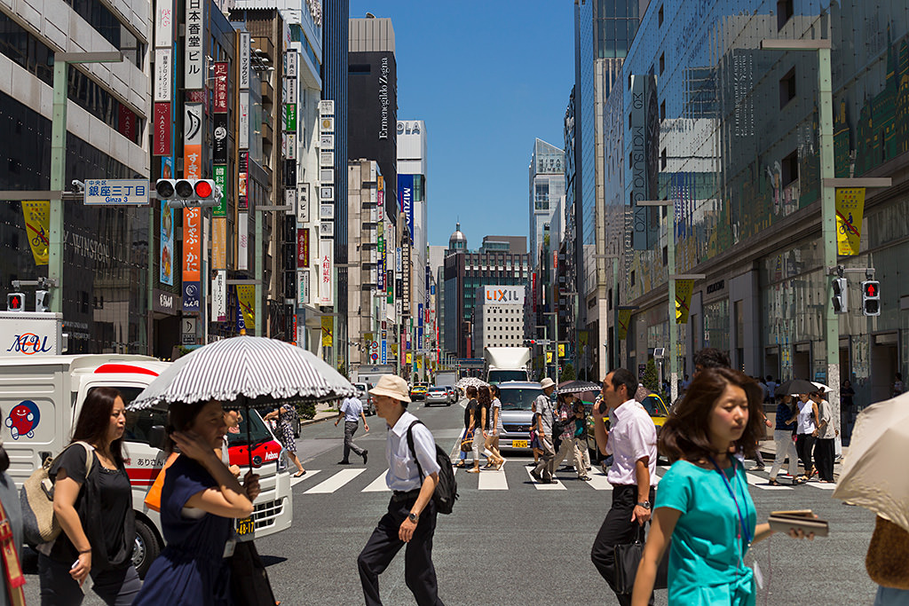 Street with passers-by captured with foreground bokeh