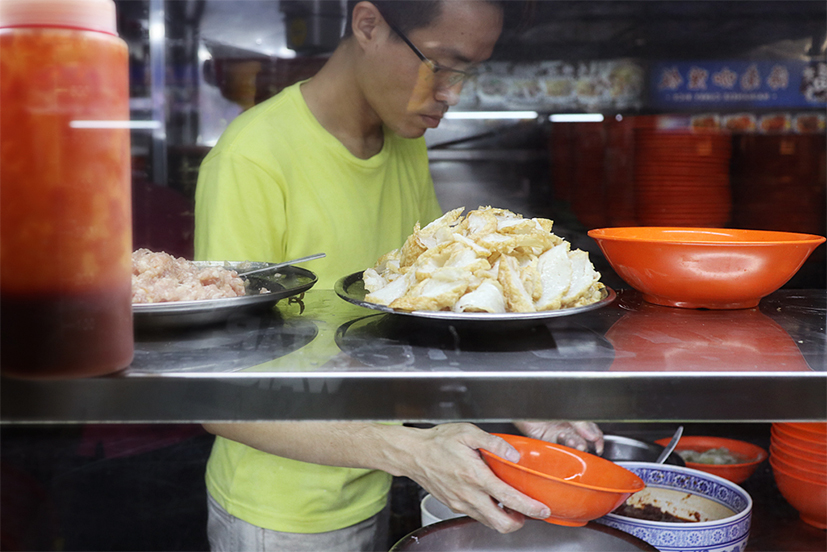 ladling some chilli paste into a bowl