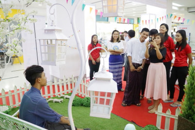 Participants take pictures at the photo booth inside the Canon showroom at Dagon Centre