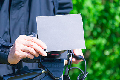 A homemade reflector board that is black on one side 