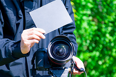 A homemade reflector board that is black on one side 