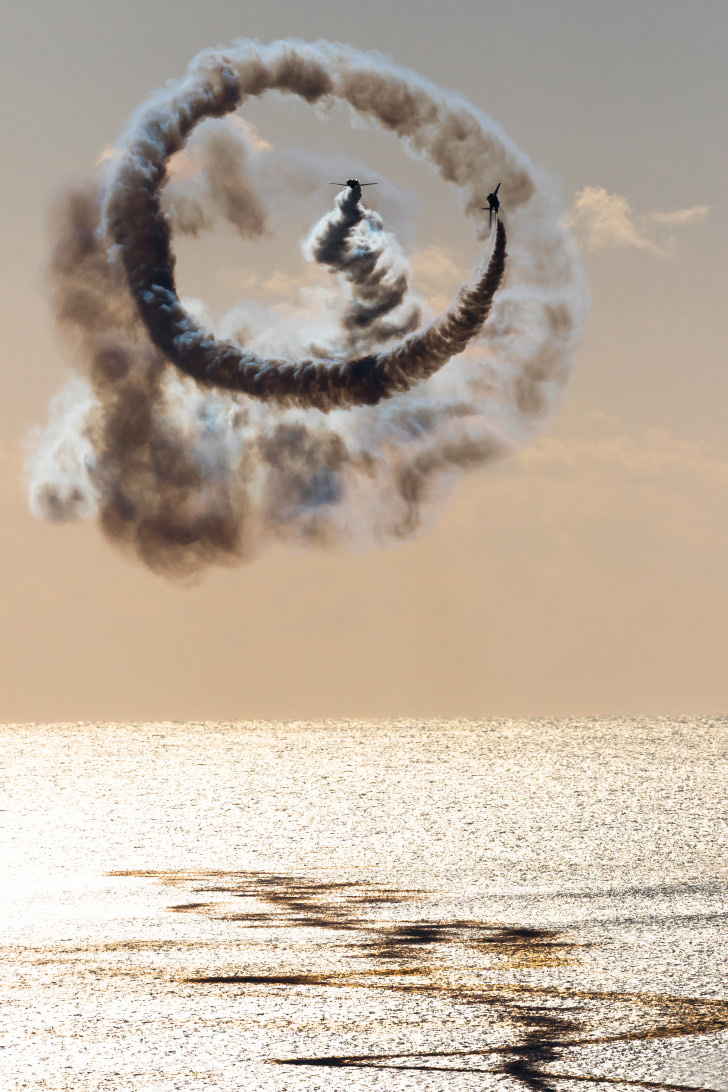 Golden hour telephoto shot of airplane smoke trails, shot with the EOS 7D Mark II