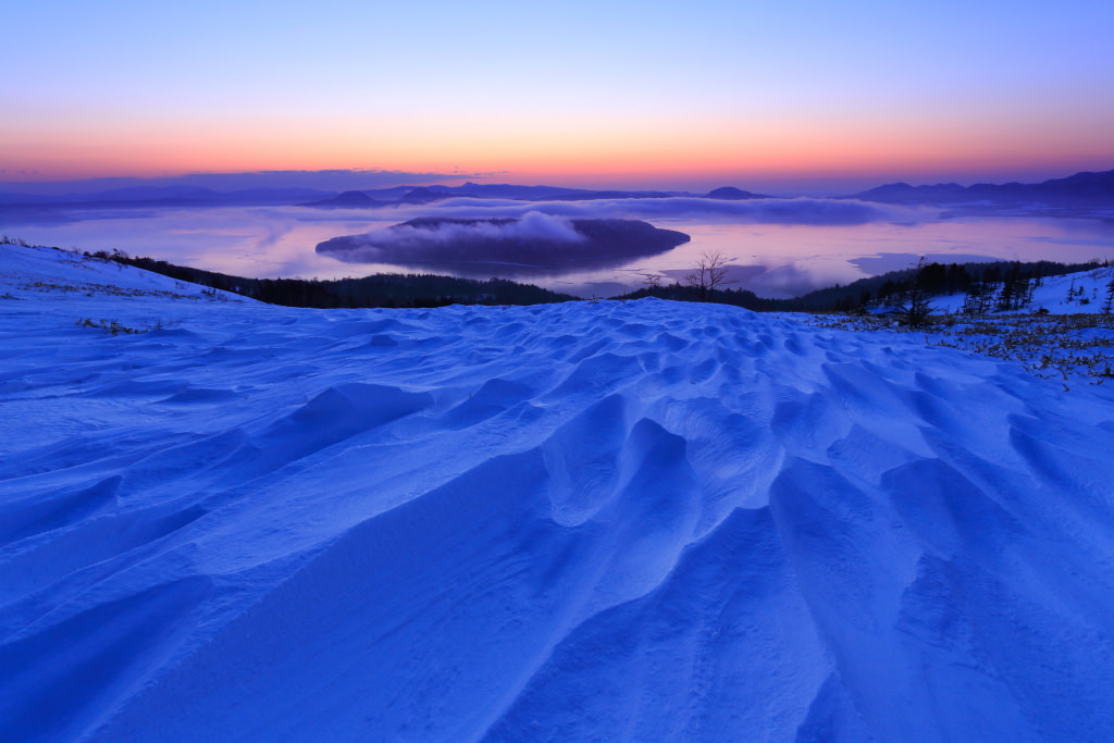 Snow ripples at Bihoro Pass overlooking Lake Kussharo