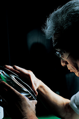 Engineer inspecting lens