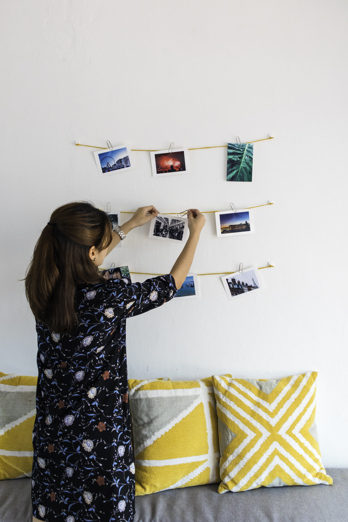 girl hanging photos