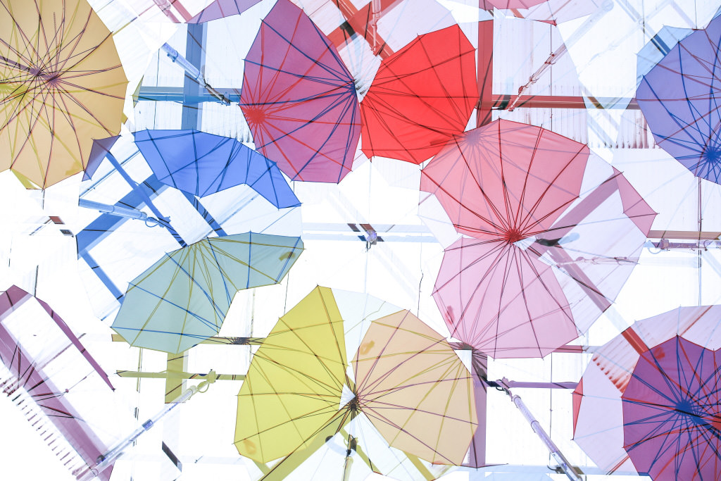 Colourful double exposure umbrellas