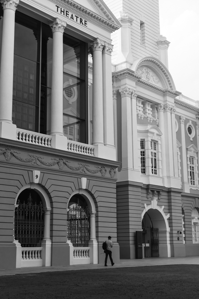black and white man with building