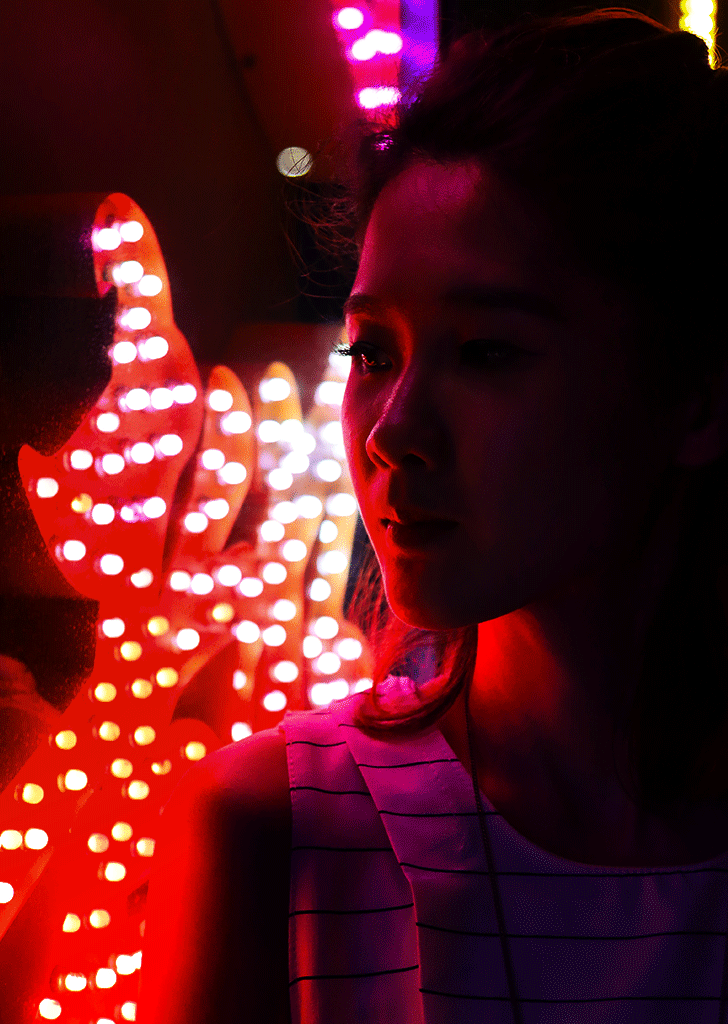 girl in front of neon lights