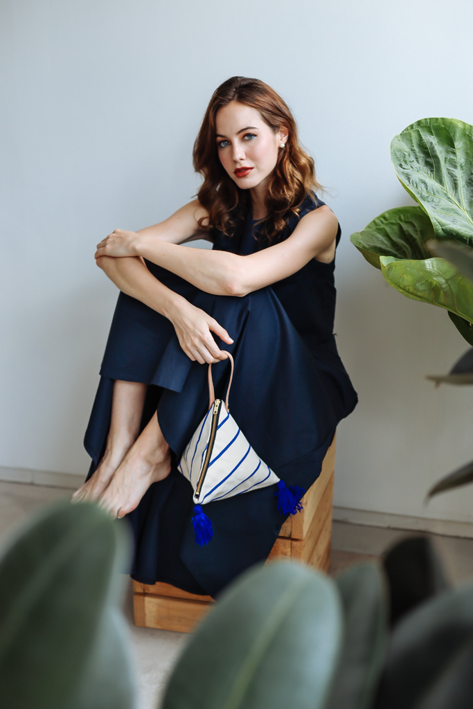 female sitting down holding bag