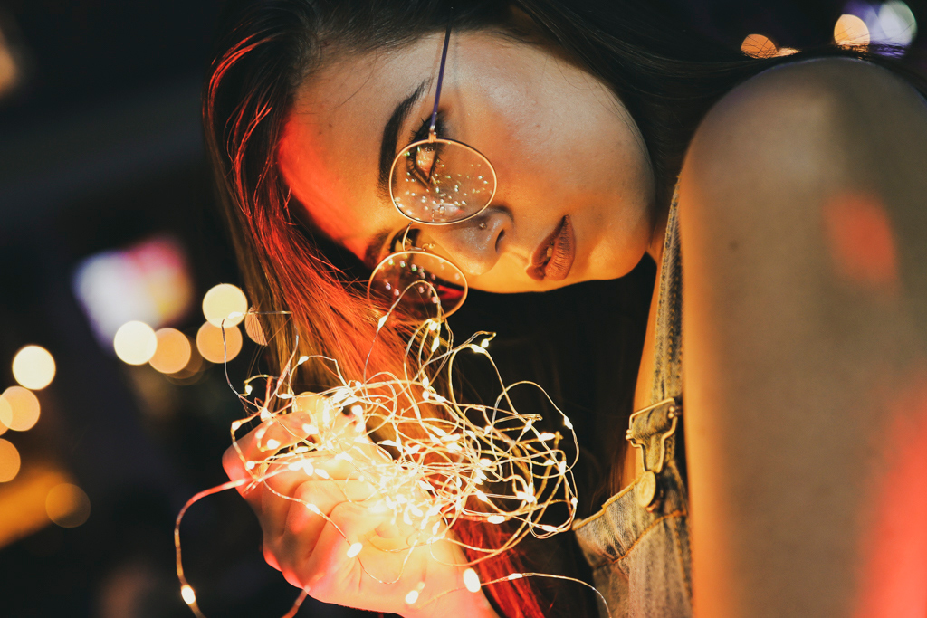 night portrait female model with fairy lights