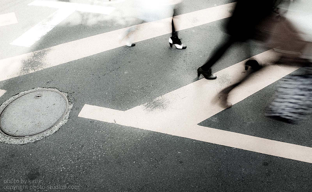Slow shutter shot of legs of passers-by