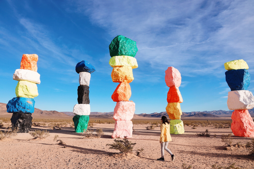 Girl against colourful art installation in the Nevada desert