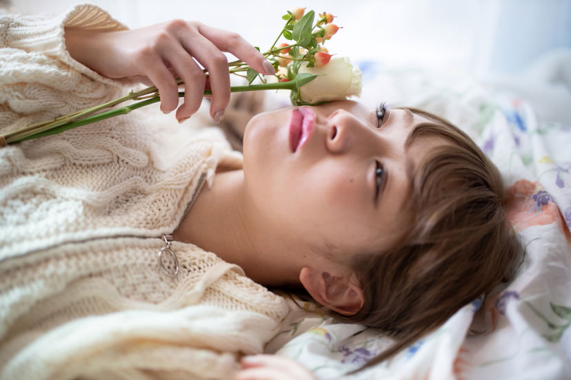 Girl lying down with flower