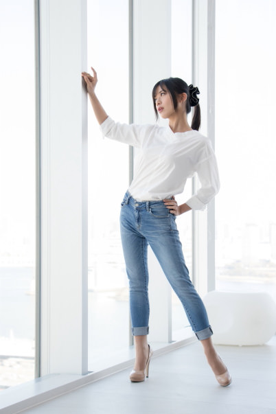 Girl posing in front of window
