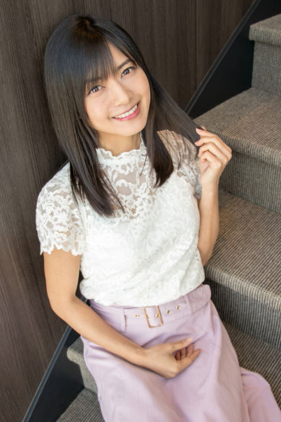 Girl posing against wooden wall