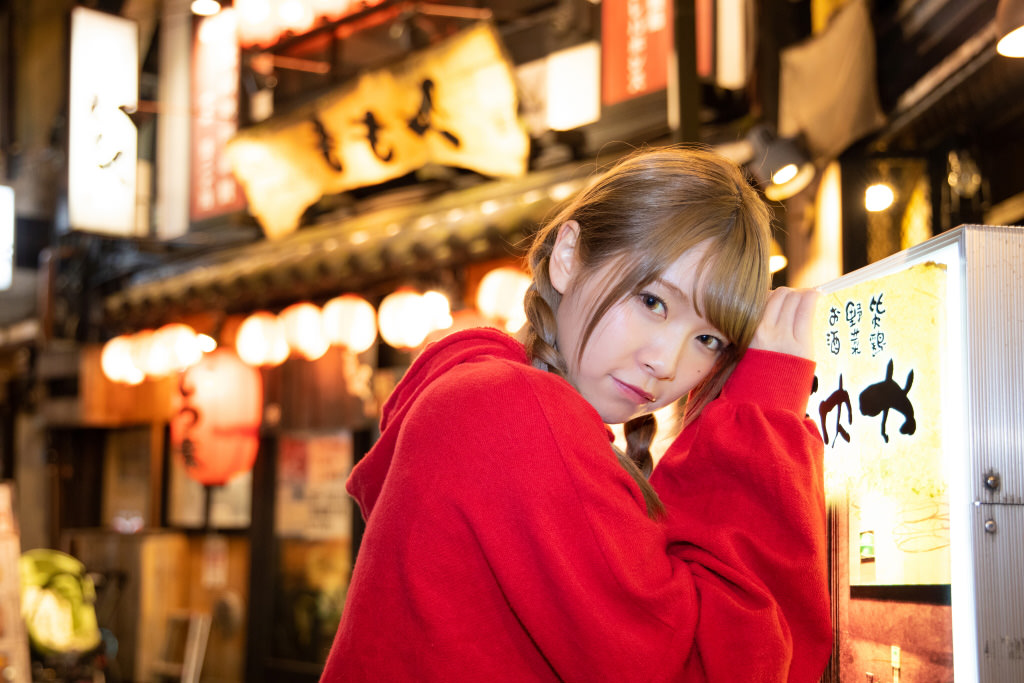 Model leaning against signboard