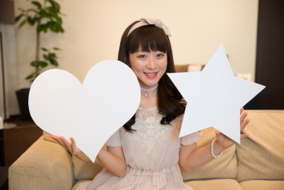 Model holding star-shaped and heart-shaped boards
