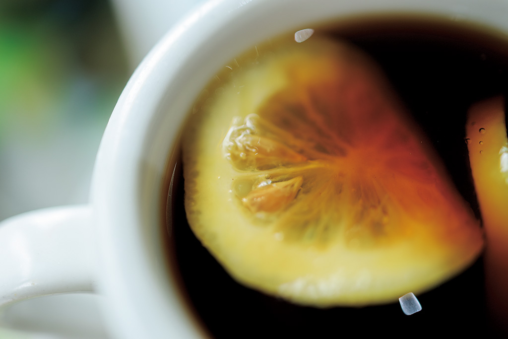 Macro shot of lemon in coffee