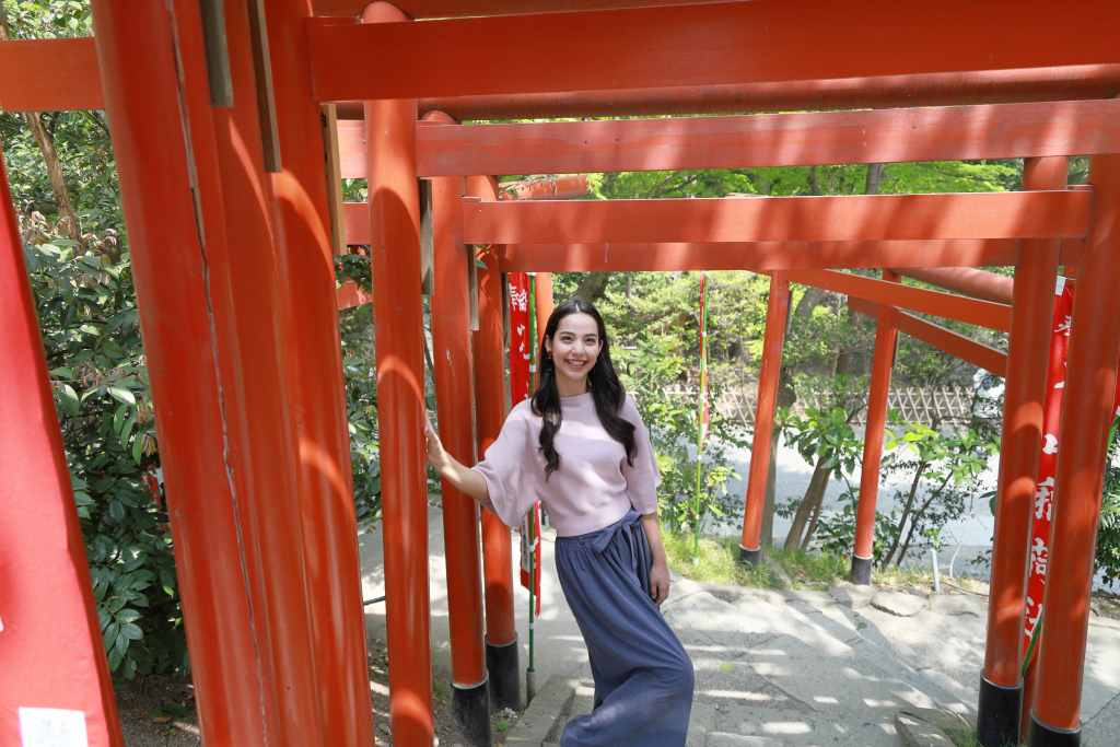 Portrait of girl in front of multiple torii