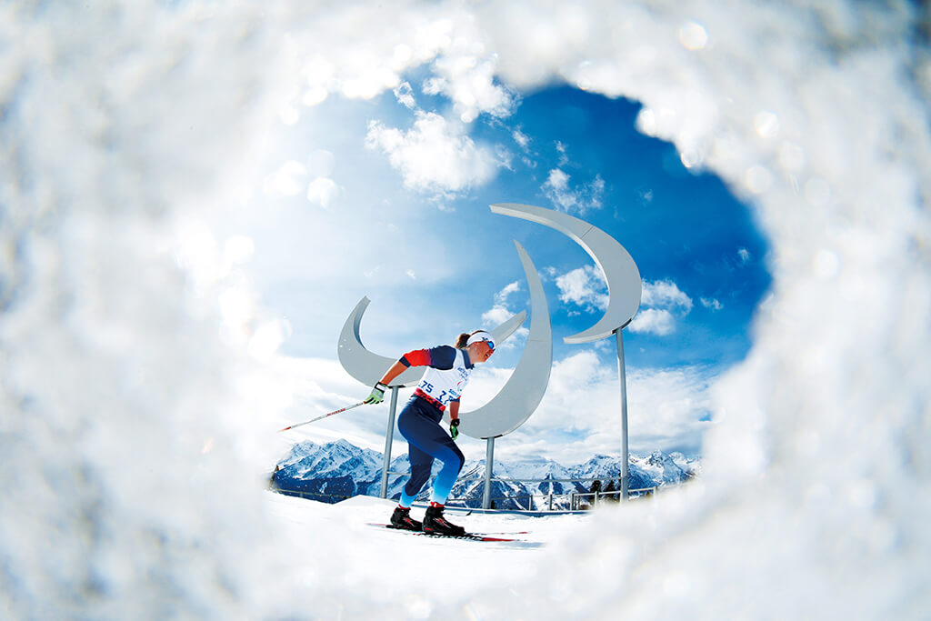 Skier in action inside a circular frame of ice