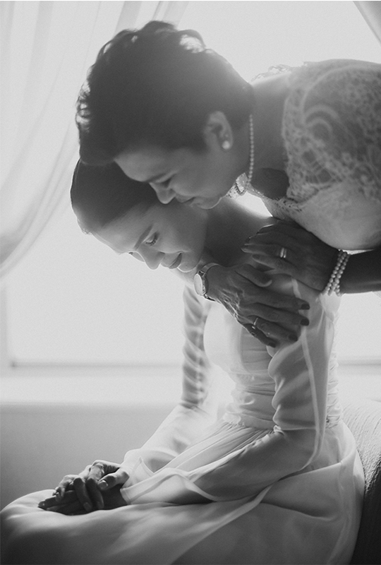 black and white photo of mother hugging daughter in wedding gown