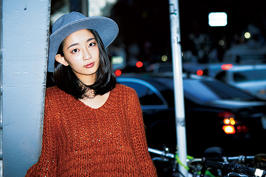Chest-up portrait with cars in the background