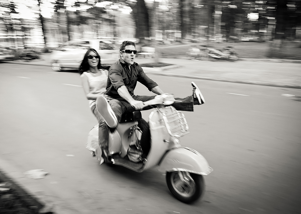 Couple being playful on a scooter