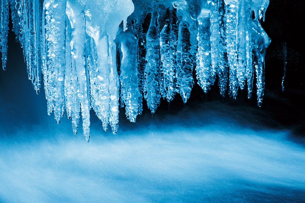 Icicles with fast-moving stream below