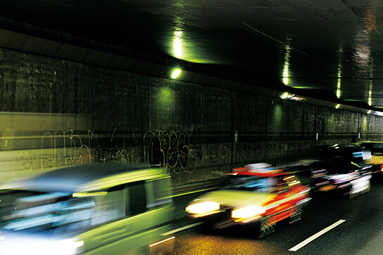 Slow shutter shot of cars in tunnel