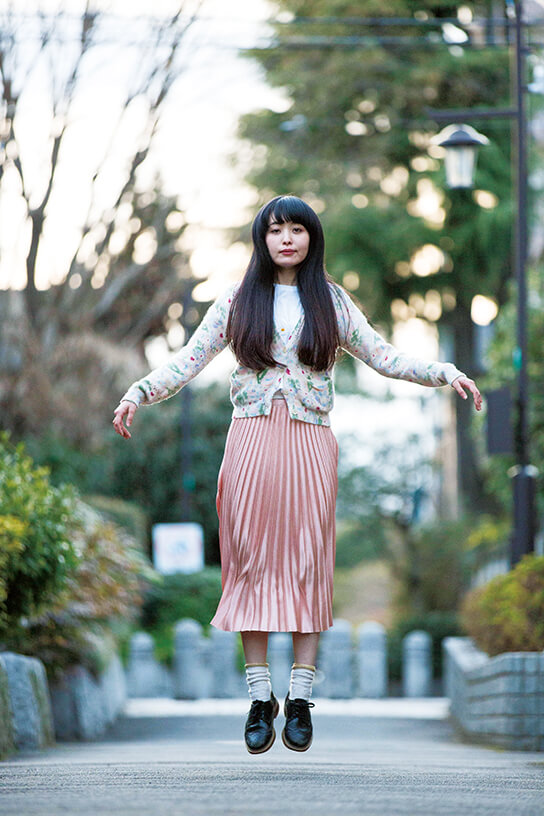 Girl in mid-jump on the streets