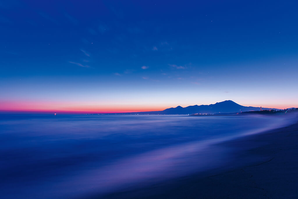 Slow shutter shot of sunrise during blue hour by the sea