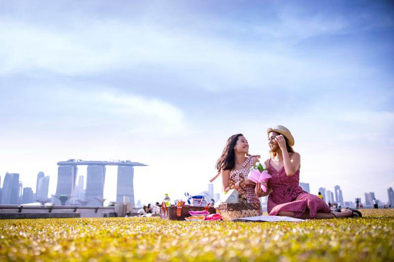 Models posing on grass at Marina Barrage rooftop