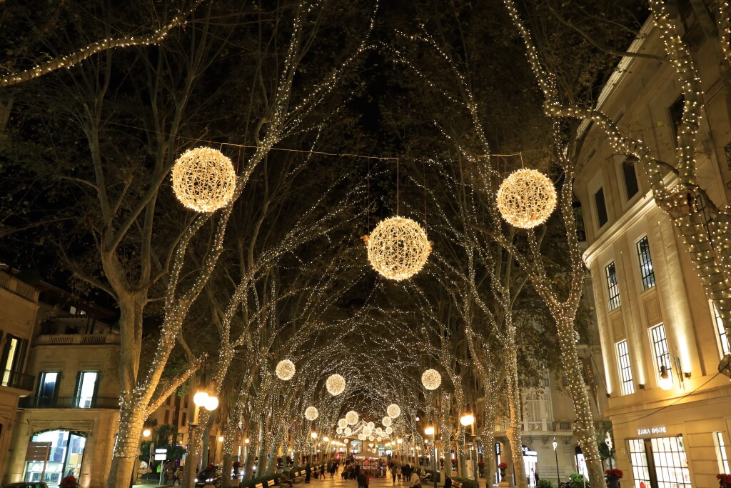 Boulevard with golden decorative lights at night