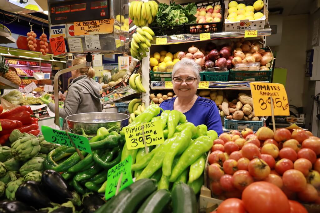 Lady with fruits and vegetables in supermarket