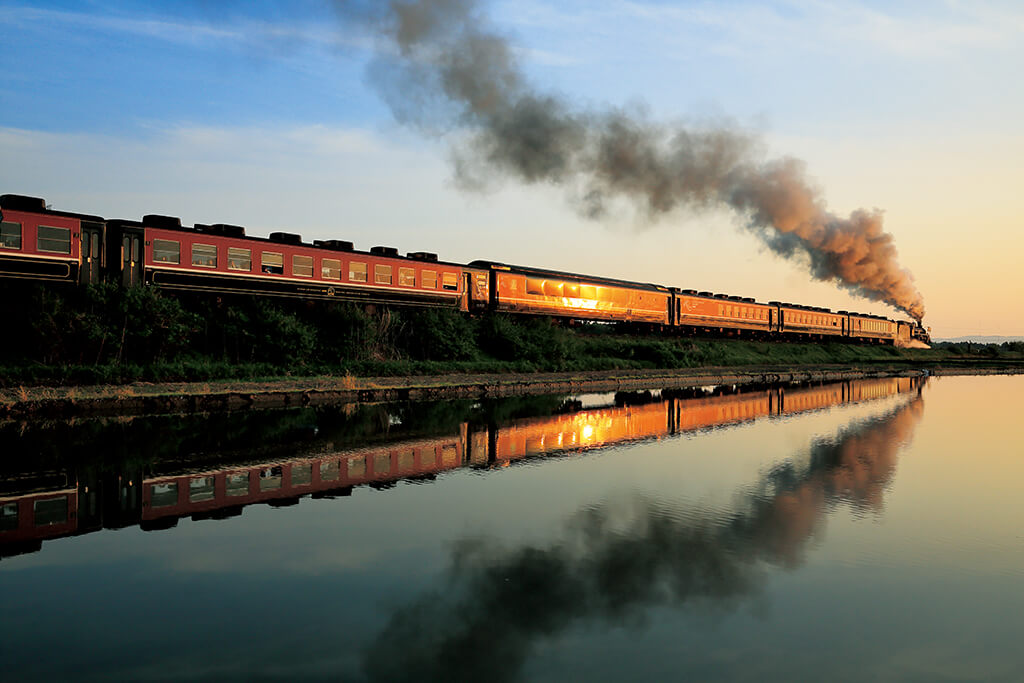 Train with water reflection, shot in front light