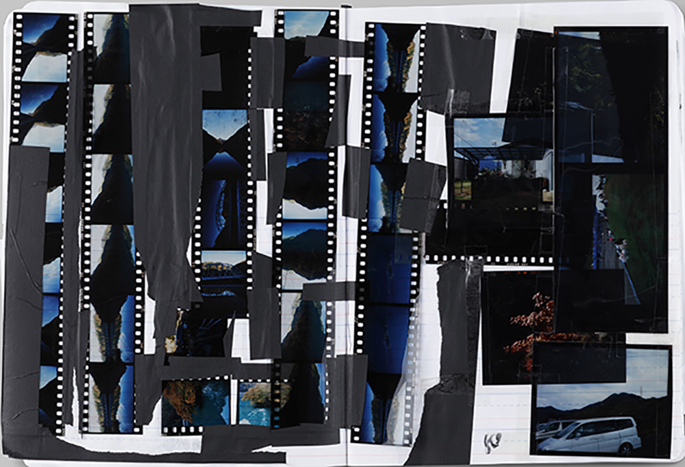 Film negatives and prints taped onto an exercise book