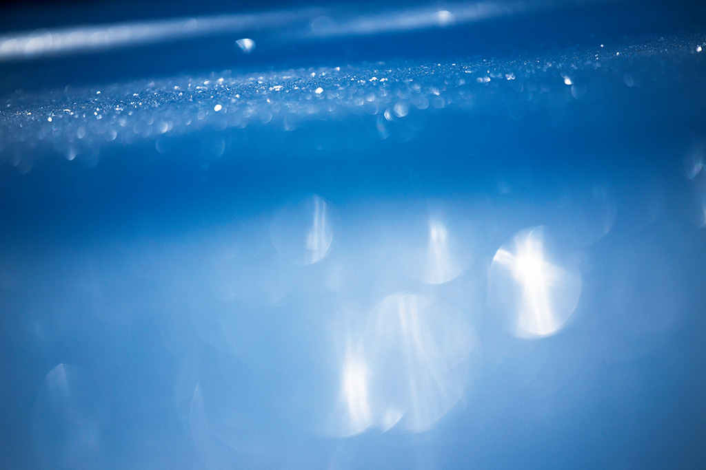 Low angle, low position shot of snow with bokeh circles