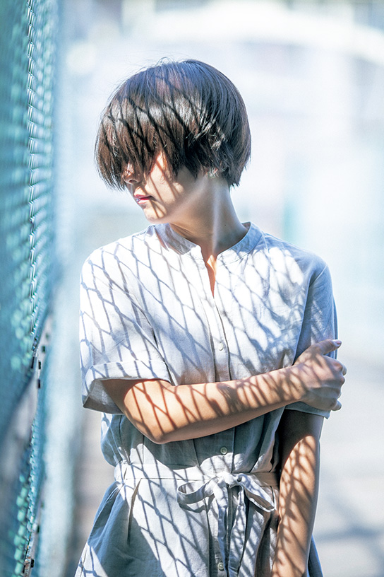 Portrait of lady with shadows of fence on her body