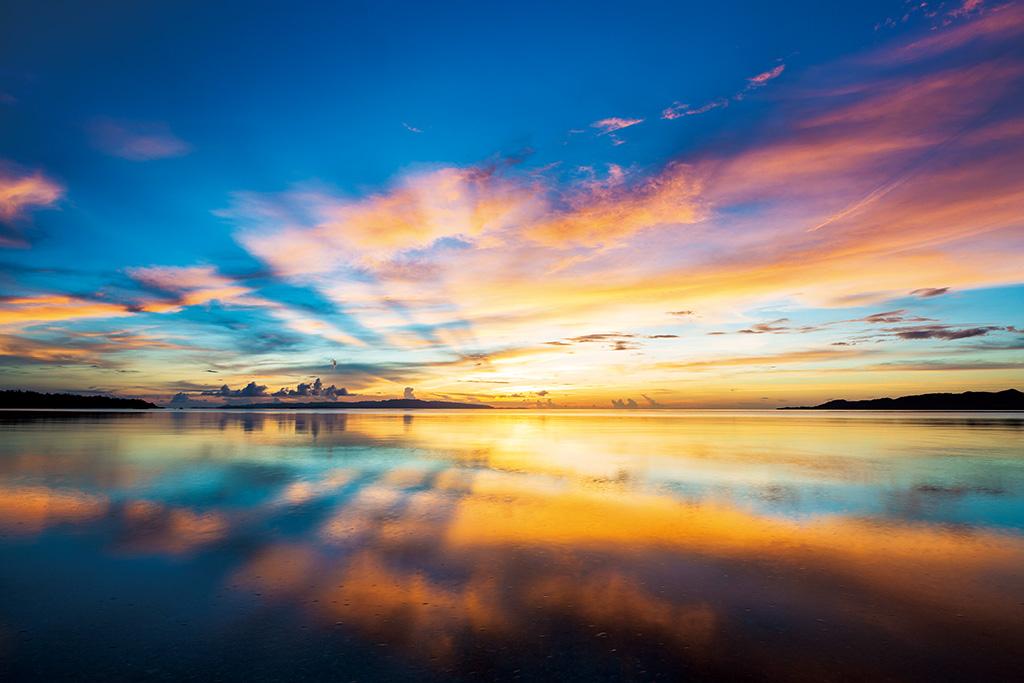Golden-blue sunset with water reflection