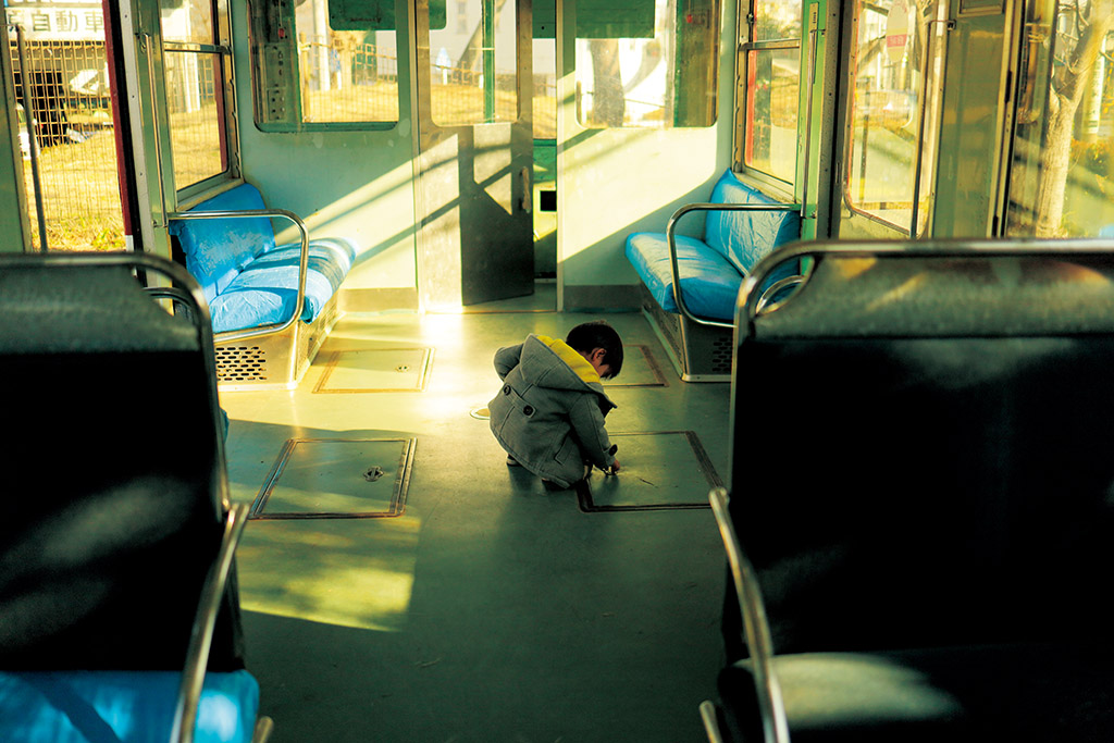 Boy playing in train carriage