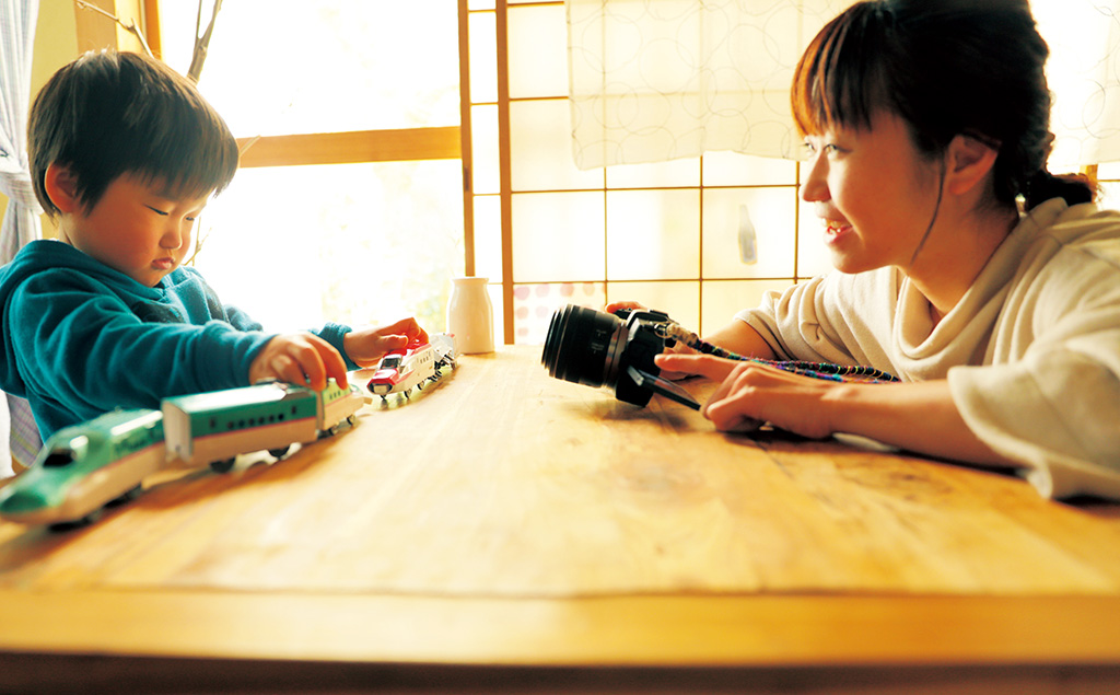 Photographer mum interacting with son