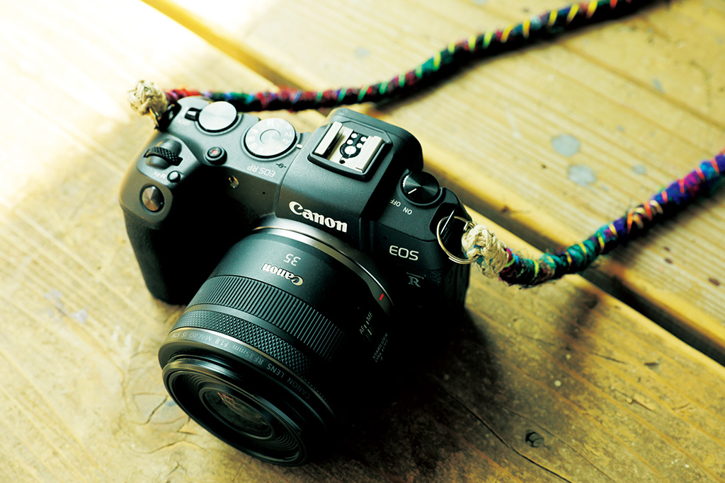 EOS RP with RF35mm lens and colourful camera strap
