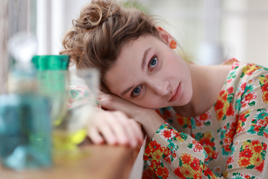 Portrait of girl with head lying on table