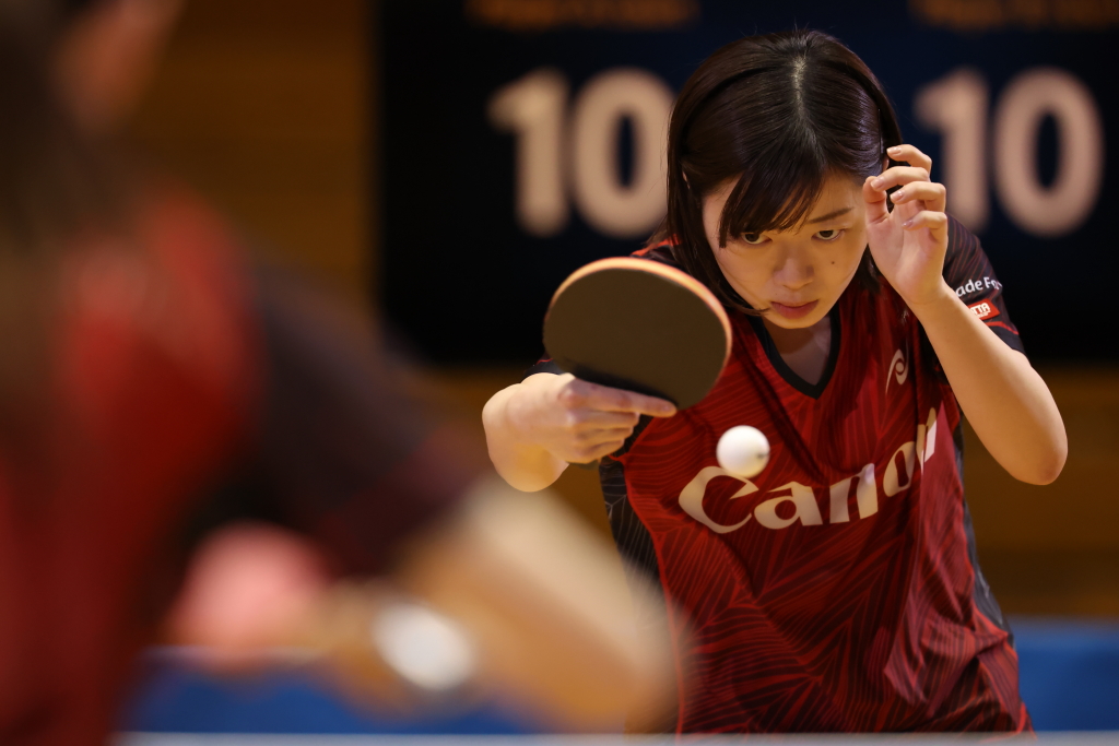 Table tennis player with eye on ball and foreground bokeh, shot on RF100-300mm f/2.8L IS USM