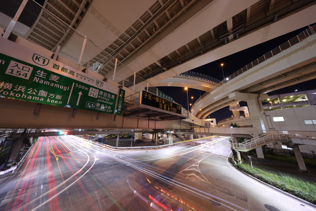 Busy highway intersection with light trails shot on an ultra-wide-angle lens