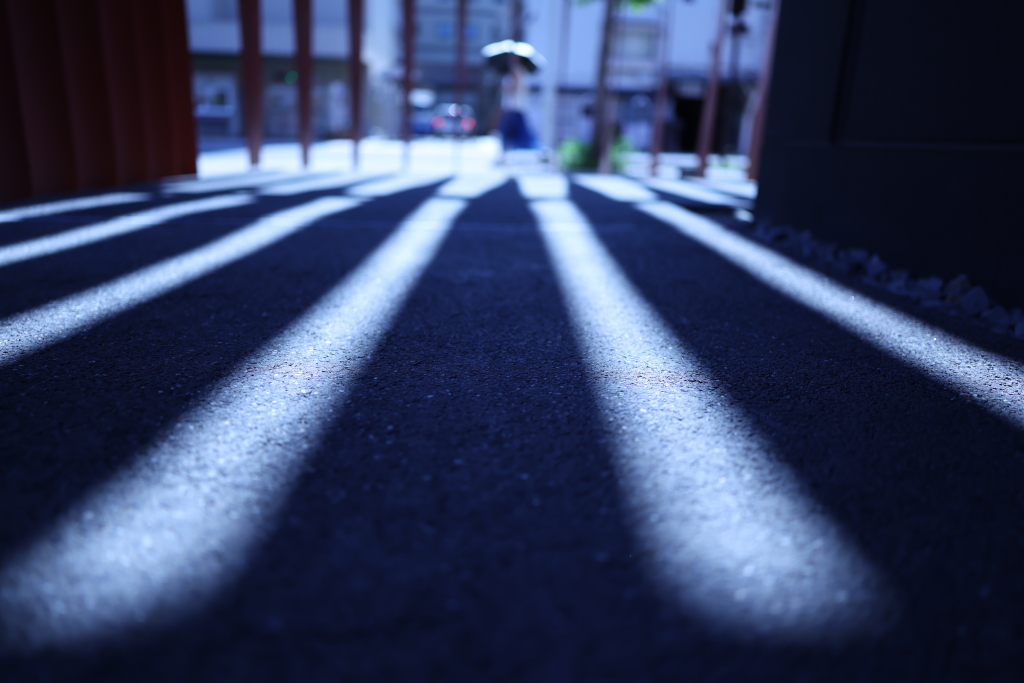 Wide-angle low angle street photo of light and shadow